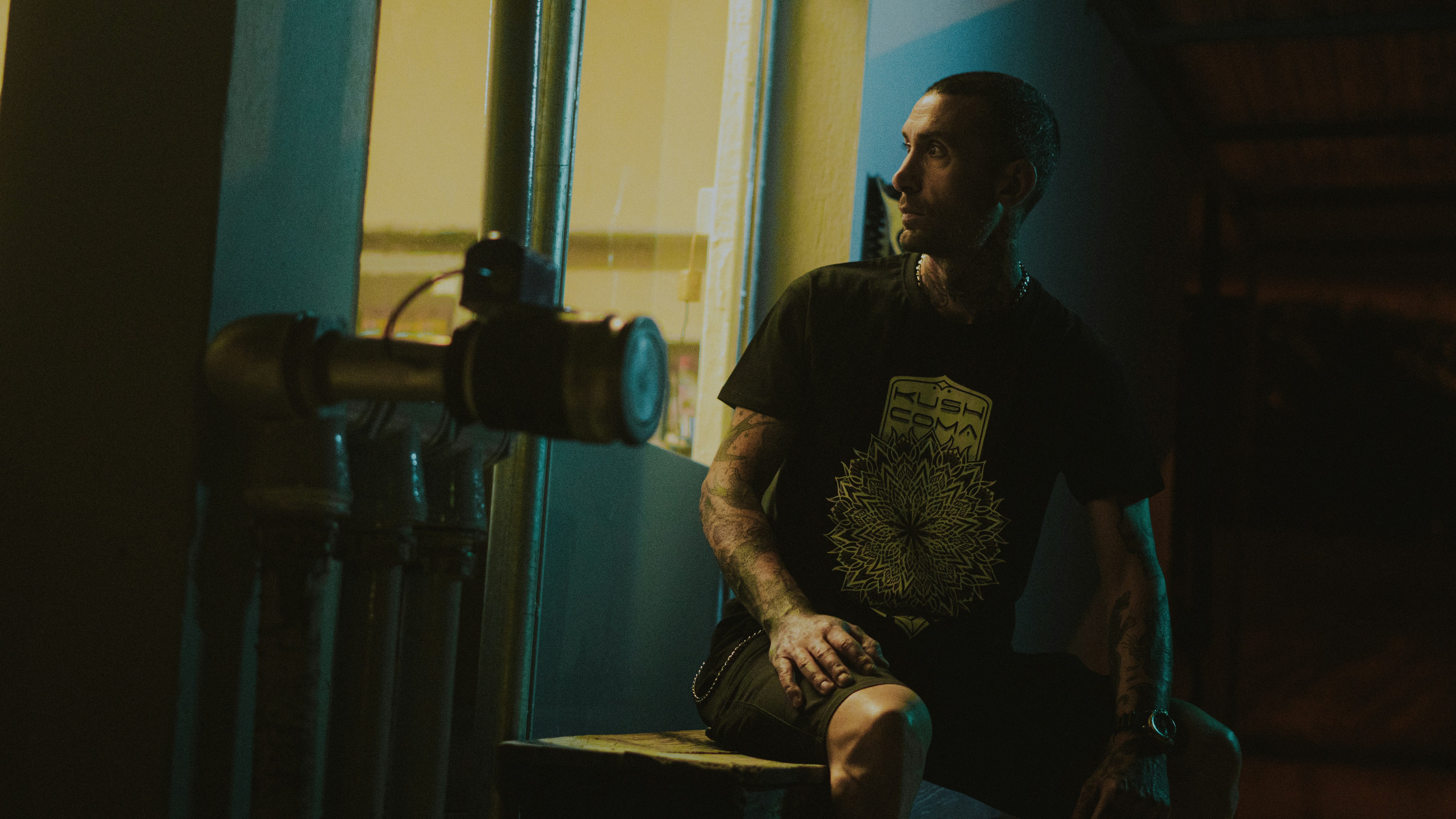 man in black crew neck t-shirt sitting on chair